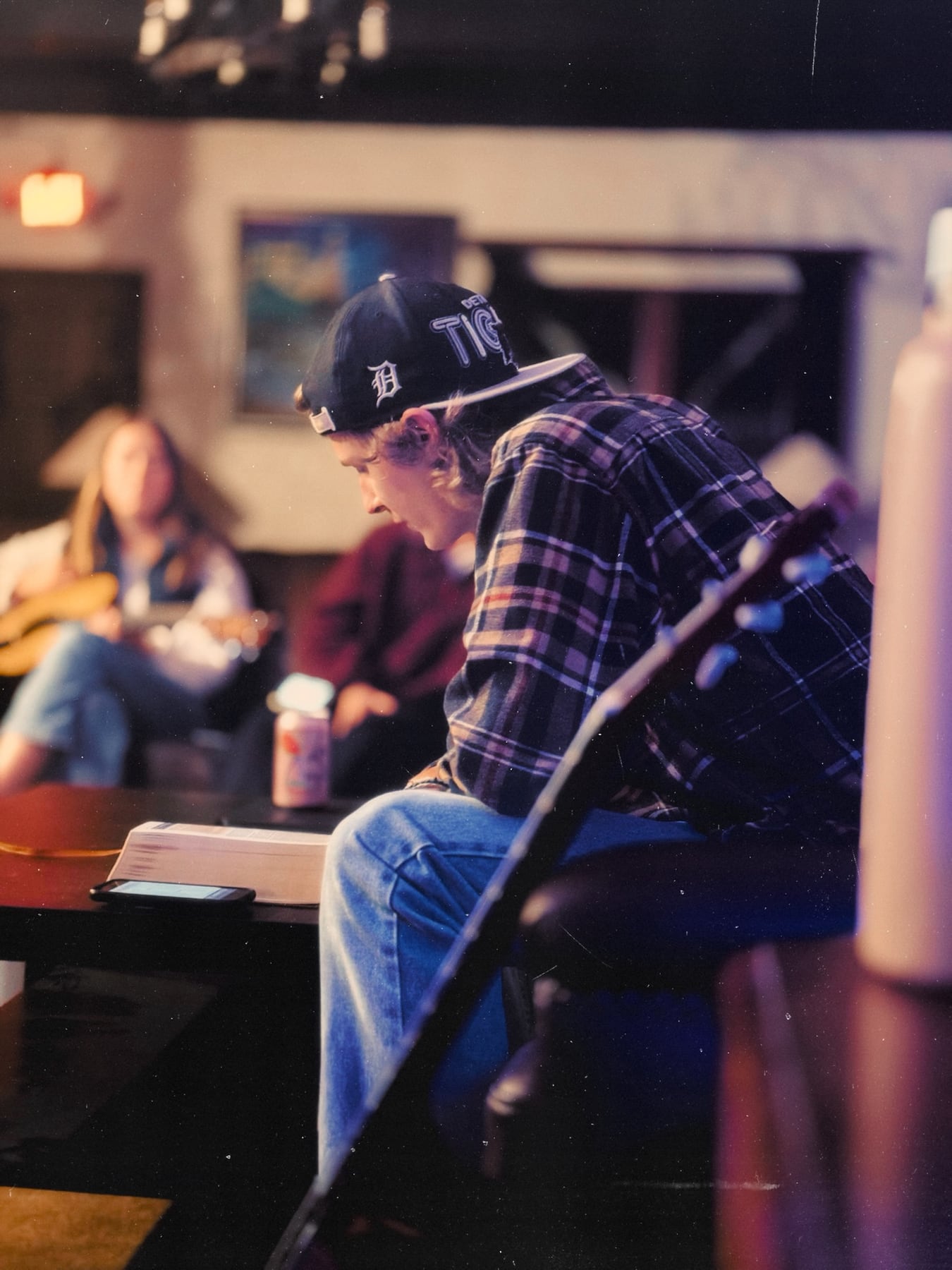 A member reading at a table during a quiet evening in the house